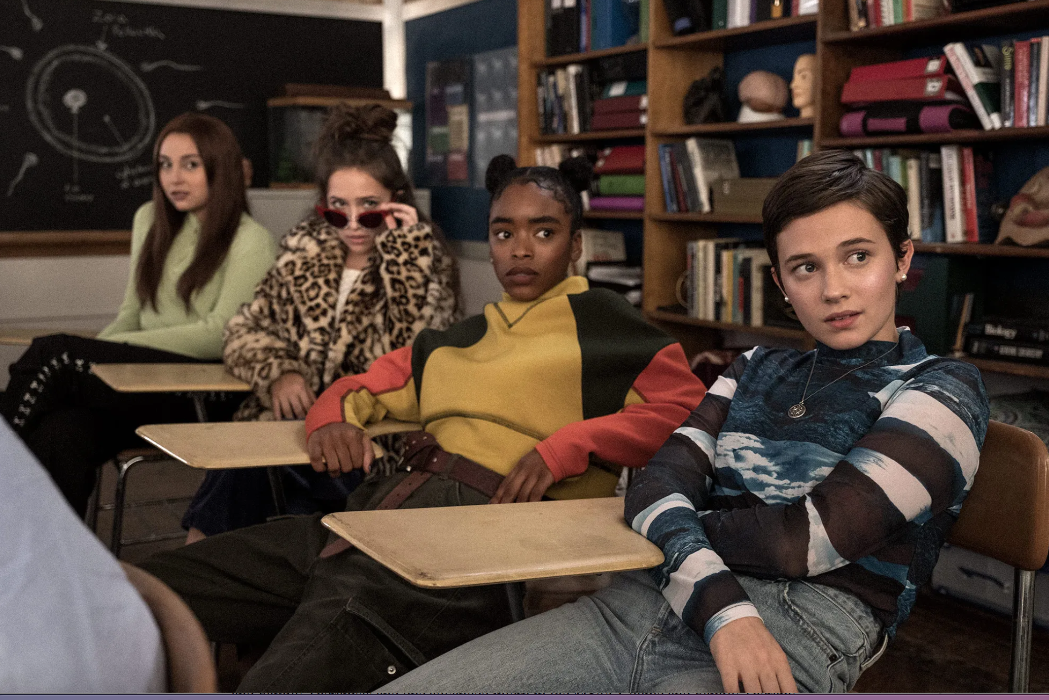 Four young girls sitting at desks in a school, still from the Craft Legacy